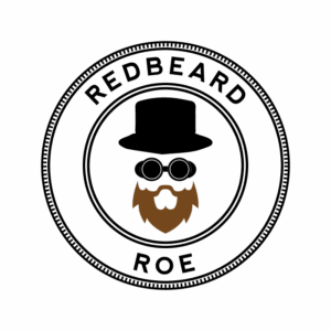 Redbeard Roe Stylized Logo Redbeard Roe logo with red beard, goggles, and top hat forming a stylized face inside concentric circles
